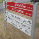 Hotel Eve and Agence Cap Nat signage and the Naked City in France